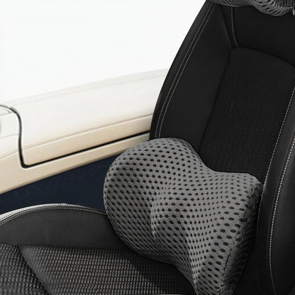 Matching car headrest and lumbar support cushions with stitched upholstery for a coordinated vehicle interior.