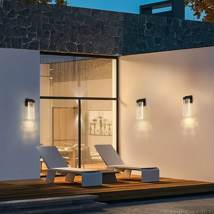 Slim vertical black wall light with a clear decorative shade for modern outdoor home decor.