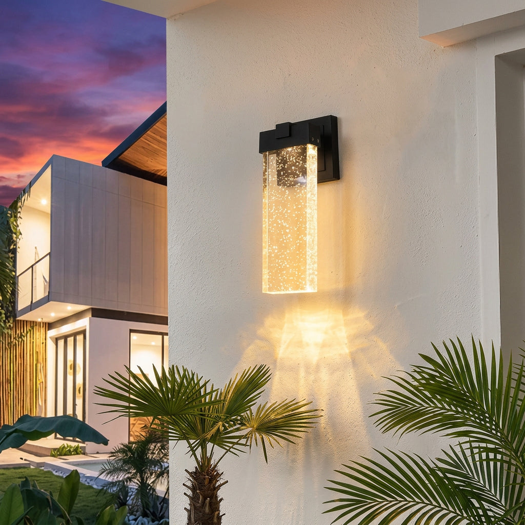 Modern black outdoor wall sconces with textured clear shades for contemporary home exterior lighting.