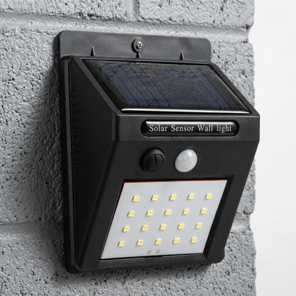 Compact black solar LED light with motion activation for garden paths, patios, and other outdoor areas.
