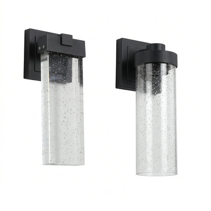 Set of two black outdoor wall lights with slim vertical designs and clear decorative crystal-bubble shades.