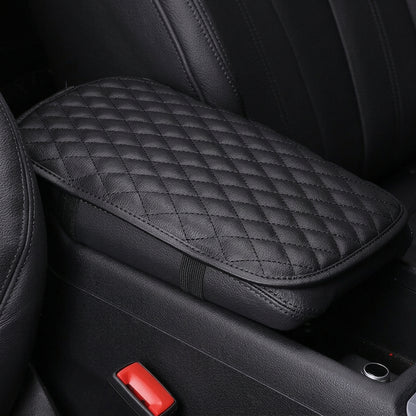Padded black car center console armrest cover designed to provide extra elbow cushioning during daily drives.